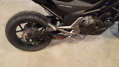a close up of a motorcycle parked in a garage