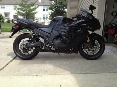 a black motorcycle parked in front of a house