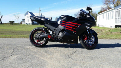 a black and red motorcycle parked on the side of the road